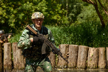 Fototapeta premium Special forces soldier with weapon take part in military maneuver. War, army, technology and people concept