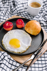 fried egg with salted red fish in a pan with coffee