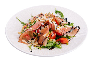 Salad with prosciutto, tomato, arugula leaves on plate