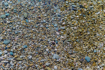 Waves on the seashore. A clear sunny day. Clear, clean sea water. Holidays on the coast. Natural background and texture.