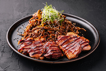 Soba beef and vegetables, Buckwheat noodles on a dark stone background