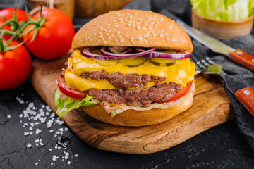Fresh tasty burger on wooden board