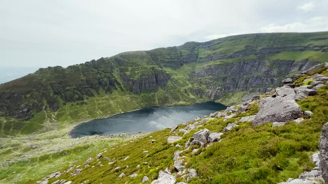 Coumshingaun Lough, Waterford, Ireland. The lake is surrounded by mountains. Travel and hiking concept