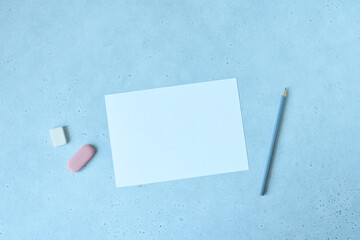 White paper sheet, grey pencil and pink eraser