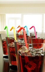 six glasses of fresh juice or cocktail with alcohol with ice cubes cocktail sticks, party quench your thirst concept