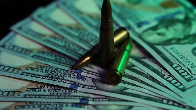 Firearm and Ammunition Industry Concept, Machine Gun Bullets on American Dollars Close Up