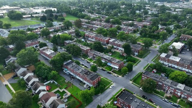 Row homes and urban residence life- aerial footage. City theme. High aerial pull back revealing sprawling city suburb in America.