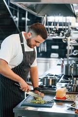 Focused on work. Chef is on the kitchen preparing food
