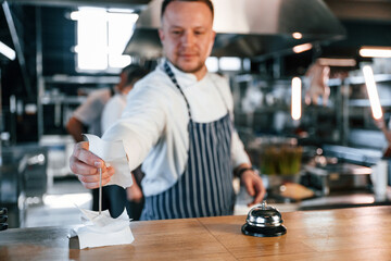 Order is complete. Kitchen workers is together preparing the food