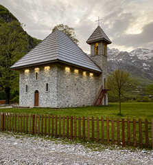 Fototapeta premium Theth, Albania, May 12, 2022 - small stone church in the afternoon