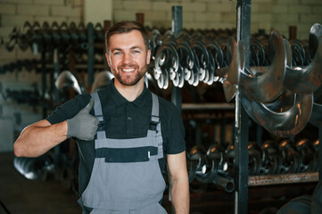 Portrait of man in uniform that is in workstation developing details of agriculture technique