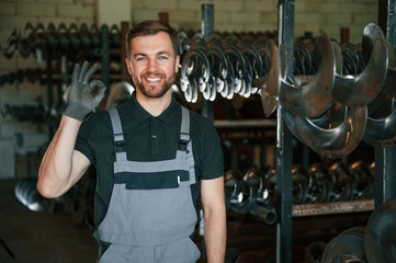 Portrait of man in uniform that is in workstation developing details of agriculture technique