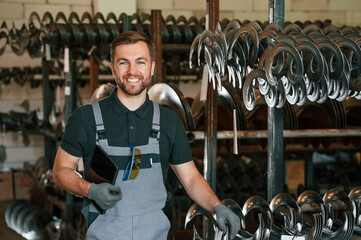 Grey uniform. Man is in workstation developing details of agriculture technique