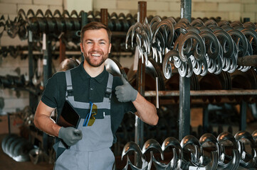 Grey uniform. Man is in workstation developing details of agriculture technique