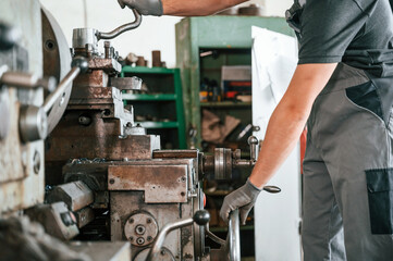 Close up view. Man in uniform is in workstation developing details of agriculture technique