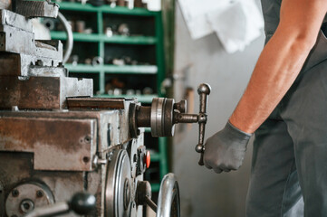 Close up view. Man in uniform is in workstation developing details of agriculture technique