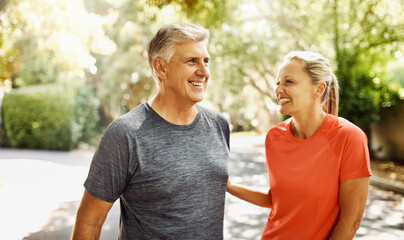 Happy mature couple keeping active, fit and healthy while jogging, running or going for walk...