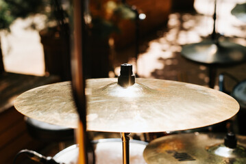 Fototapeta na wymiar Drum kit, hi-hat cymbals at a street music festival on a sunny day. Close-up, selective focus