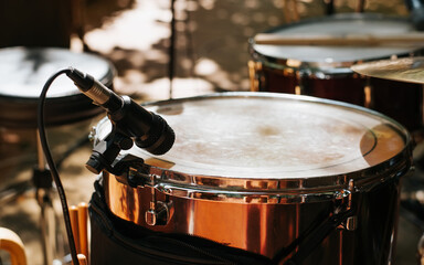 Fototapeta na wymiar Drum set with a microphone at a street music festival. Close-up snare drum, selective focus on microphone