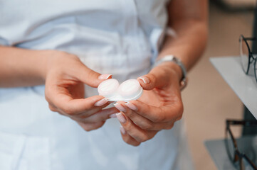 Close up view of woman's hands that holding lenses