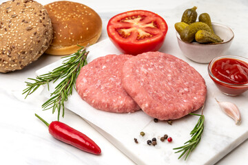 Patty of minced meat for burger. Grey background. Top view.