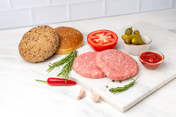 Patty of minced meat for burger. Grey background. Top view.