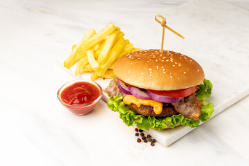 Homemade burger with beef and crispy bacon and potatoes fries 
