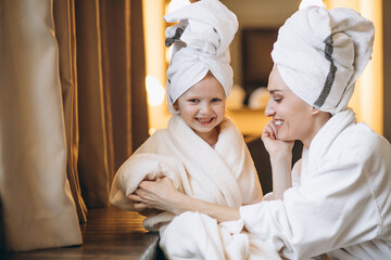 Mother and daughter in bathrobes