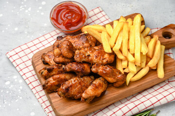 lunch fast food chicken wings with ketchup and potatoes fries