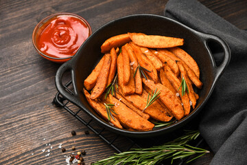 Vegan food baked Sweet Potatoes chips on a wooden Background