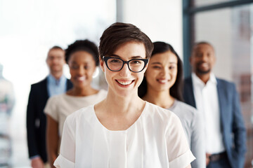 Fototapeta premium A happy diverse group of smart and successful businesspeople with a satisfied leader or manager. Portrait of a team of corporate professionals smiling about company growth and development