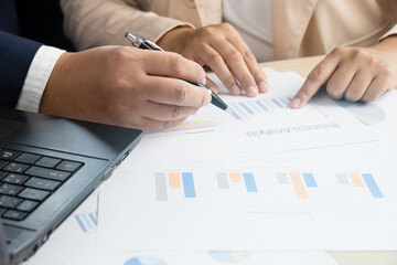 Business persons discuss on paper document chart and graph report teamwork and leadership concept