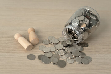 Home financial concept saving for family. Save money coin Thai baht in a jar