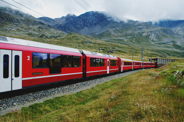 Fototapeta na wymiar Swiss mountain train Bernina Express crossed Alps. St.Moritz, Switzerland