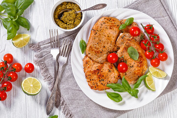 tomato basil pesto fried pork cutlets on plate