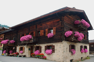 Fototapeta na wymiar Traditional alpine cottage in Livigno, Italy