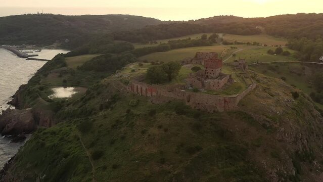 Aerial of Impressive Medieval Fortress of Hammershus Ruins at sunset, Denmark