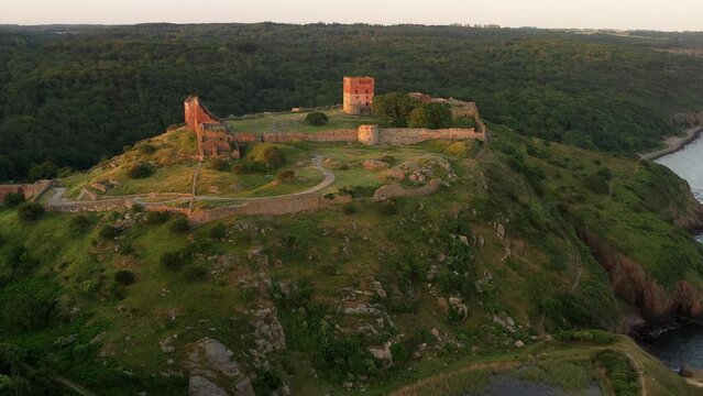 Aerial of Impressive Medieval Fortress of Hammershus Ruins at sunset, Denmark