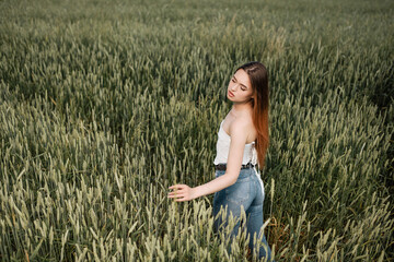 Beautiful girl posing in wheat field. Emotions of a girl