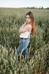 Beautiful girl posing in wheat field. Emotions of a girl