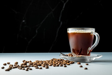 Cup of coffee with milk on a dark background. Hot latte or cappuccino made with milk on a wooden table with copy space, on a gray background 