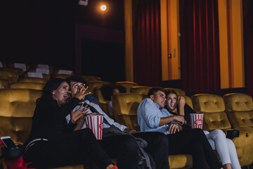 Young and adult audience scared and horror with watching movies in cinema.