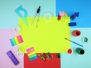     school supplies on abstract colorful background texture        