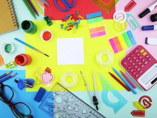        school supplies on abstract colorful background texture                  