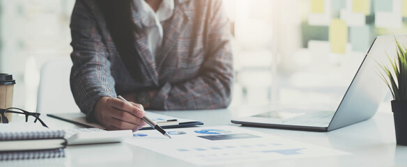 Business people or accountants are analyzing graphs on finance, investment, graph chart business strategy ideas, data analysis technology.