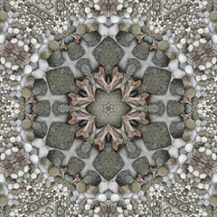 pebble patterns from many grey and white smooth stones arranged to form hexagonal floral fantasy creative designs