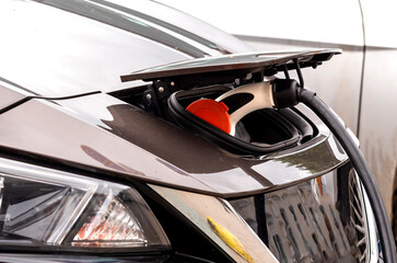 Obraz premium Electric car at the charging station. Ecology. Eco-friendly transport