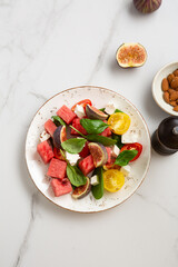 Overhead view of summer food salad tomatoes fig watermelon