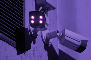 CCTV wireless surveillance camera with illuminated ir lights mounted on wall, night time observe...