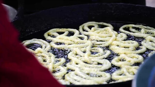 Jalebi a famous indian sweet food in making jalebi are fried in oil